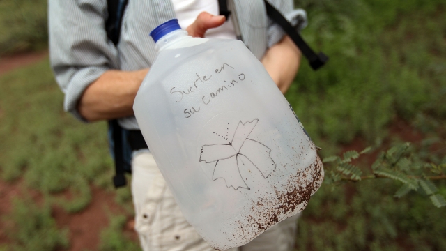 Volunteer displays a water for migrants crossing into Arizona from Mexico