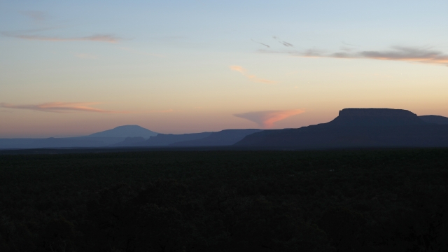 Bluffs and mountains are silhouetted during sunset at Bears Ears National Monument in Utah.