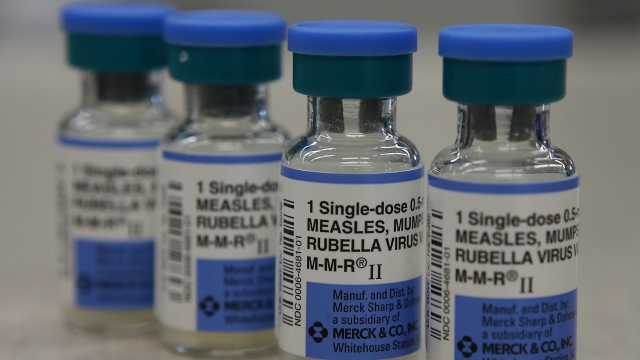 Vials of the measles vaccine are displayed on a counter