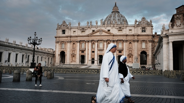 Nuns walking in through of St. Peter's square.