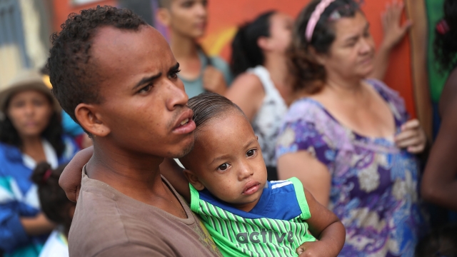 Venezuelan migrants wait outside a shelter for food and other necessities.