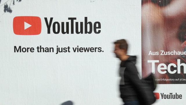 A man walks past a YouTube advertisement in Berlin, Germany in October of 2018