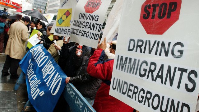 Immigrants and community leaders protest the New York State Department of Motor Vehicles.
