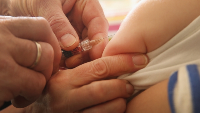 Doctor injects vaccine