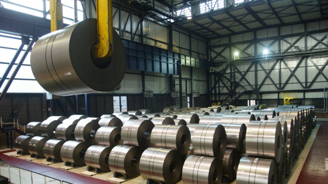 Giant spools of finished steel in a warehouse