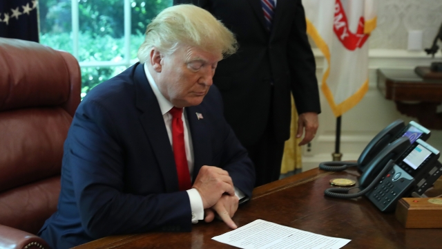 President Donald Trump signs an executive order imposing new sanctions on Iran