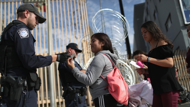 CBP officers check migrants' IDs