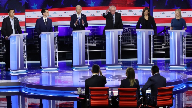 Democratic presidential candidates debate on stage.