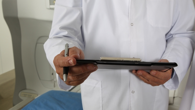 A doctor holds a clipboard
