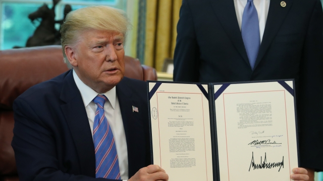 President Trump shows the media a bill for border funding legislation