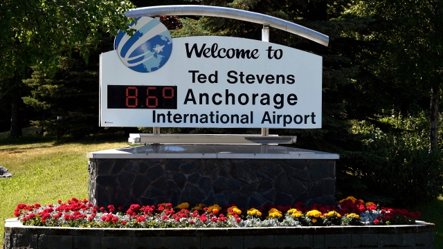A welcome sign at Ted Stevens Anchorage International Airport indicates the temperature is 86 degrees Fahrenheit