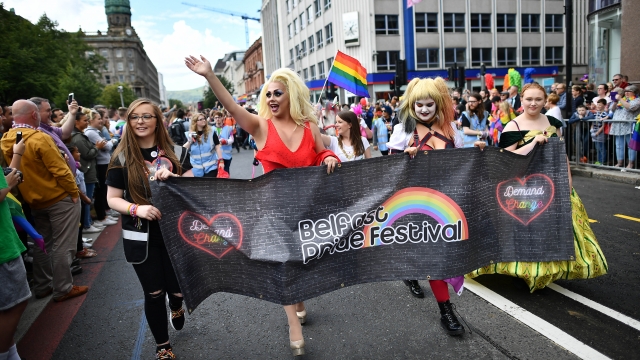 Participants wave to the large crowd of spectators at Belfast Gay Pride 2017