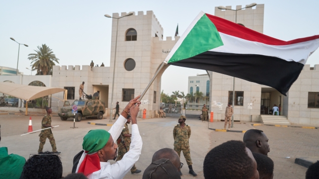 Protesters stand outside Sudanese military base