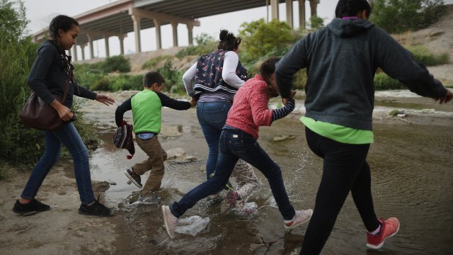 Migrants make their way to cross the border between the U.S. and Mexico at the Rio Grande river on May 20, 2019