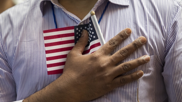 A man holds a U.S. flag to his chest