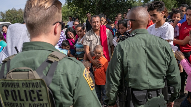 U.S. Border Patrol agents watch over immigrants after taking them into custody on July 02, 2019 in Los Ebanos, Texas