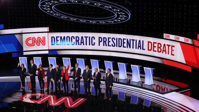 Democratic presidential candidates on stage before debate.