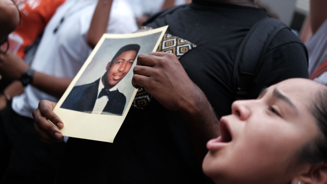 A protester holds up a photo of Eric Garner