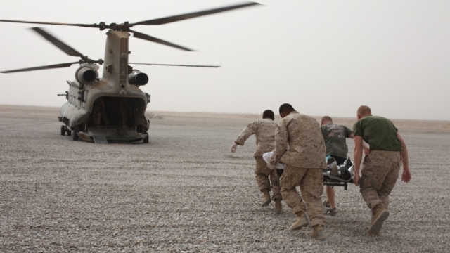U.S. soldiers rescue an Afghan civilian after IED blast