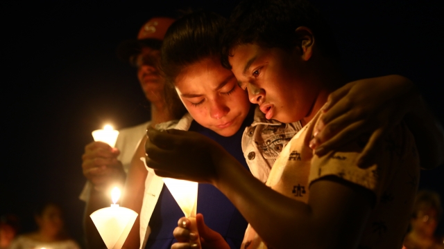 People attend a candlelight prayer vigil for victims of a shooting in El Paso