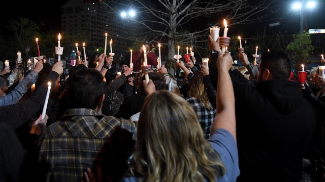 People hold up candles during a vigil in Las Vegas for victims of the shooting at Marjory Stoneman Douglas High School.