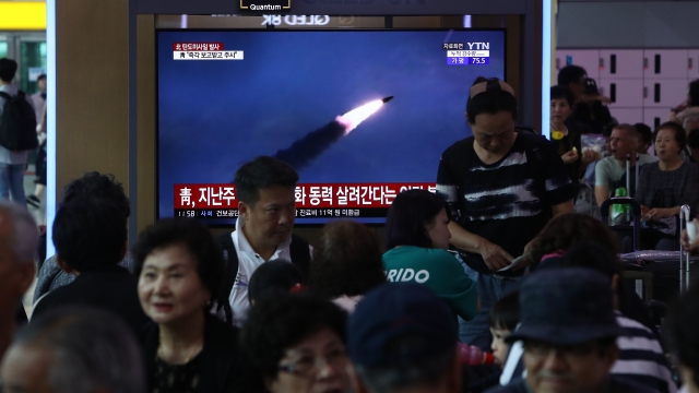 A crowd in South Korea watches North Korea launch a missile