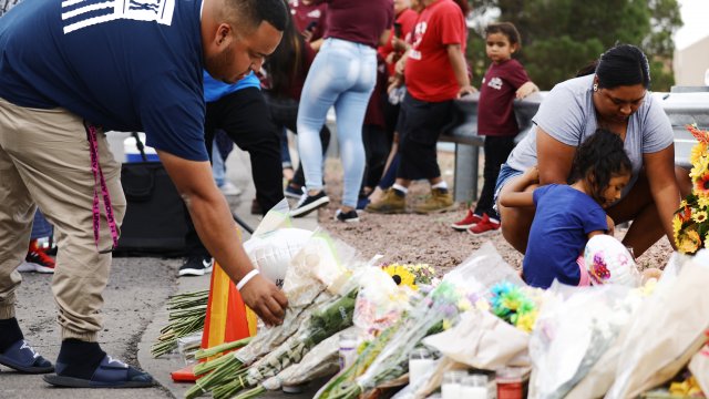 People leave flowers at a makeshift memorial outside Walmart in El Paso, Texas where at least 20 people were killed.