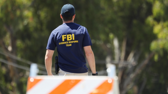 An FBI agent walks toward the site of the Gilroy Garlic Festival after a mass shooting there on July 29, 2019