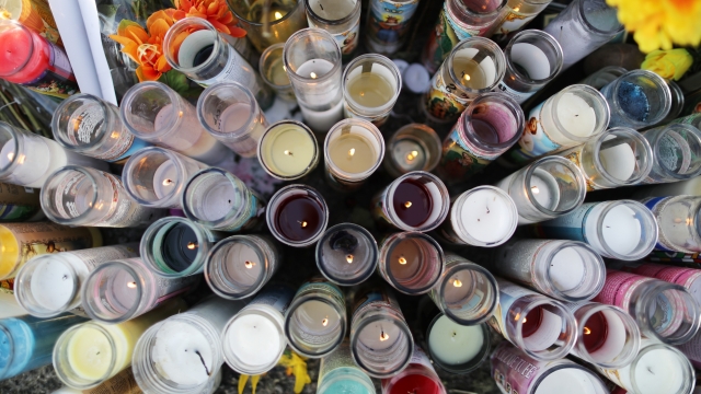 Candles are lit at a makeshift memorial honoring victims of a mass shooting in El Paso, Texas.