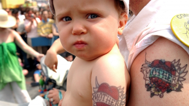 Baby and parent with matching tattoos
