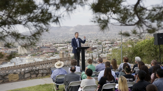 Beto O'Rourke gives a speech with El Paso in the background