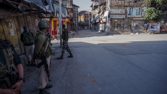 Indian paramilitary troopers stand guard amid curfew-like restrictions in the Habba Kadal, on August 18, 2019