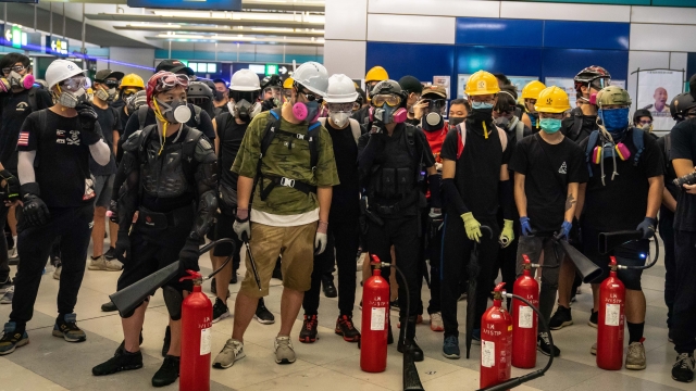 Protesters stand off against riot police during a protest at the Yuen Long MTR station on August 21, 2019 in Hong Kong