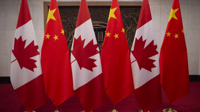 Flags from China and Canada placed side by side.