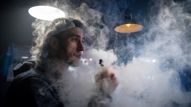 A man uses an e-cigarette