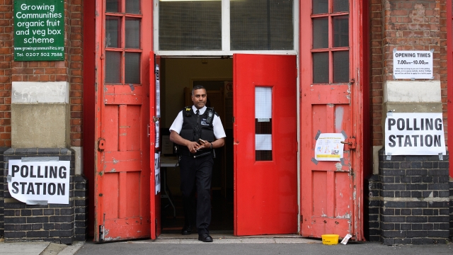 Officer stands in doorway of polling station in the U.K.