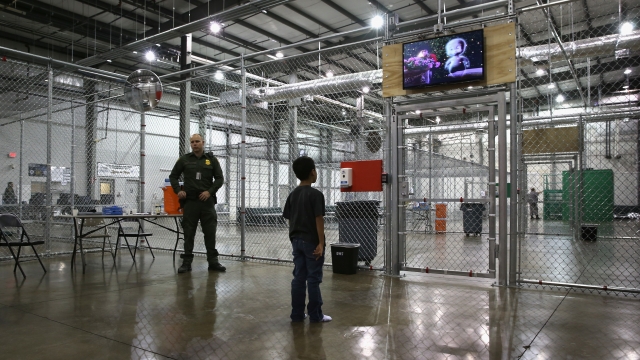 A boy from Honduras watches a movie at a detention facility run by the U.S. Border Patrol on September 8, 2014 in McAllen, TX