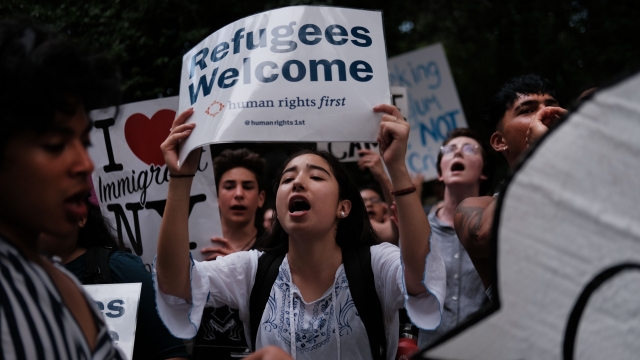 Hundreds of people gather to protest treatment of migrants and refugees in the U.S.