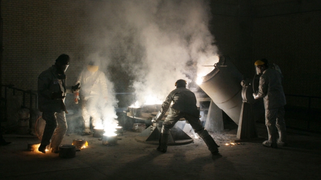 Men work inside of an uranium conversion facility March 30, 2005 just outside the city of Isfahan