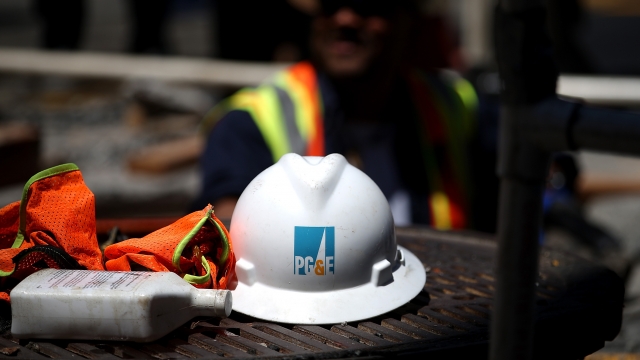 A hard hat sits on the ground at a PG&E work site.