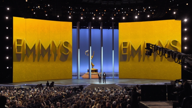 Colin Jost and Michael Che speak onstage at the 70th Emmy Awards