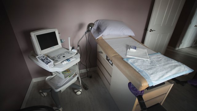 An ultrasound machine sits next to an exam table.