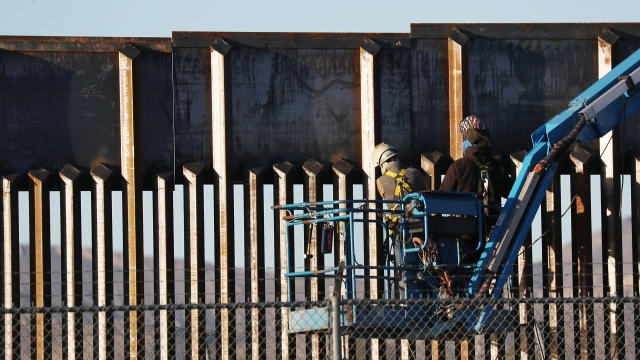 Workers construct part of a barrier along the U.S.-Mexico border