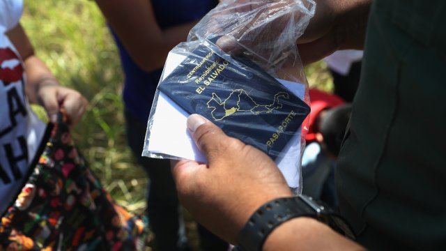 A U.S. Border Patrol agent inspects a Salvadoran passport