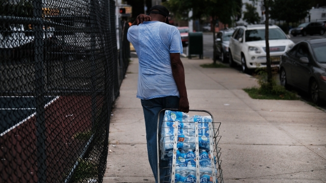 Newark resident carries bottled water in response to high lead levels