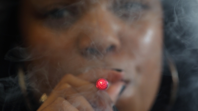 A woman smokes an E-Cigarette