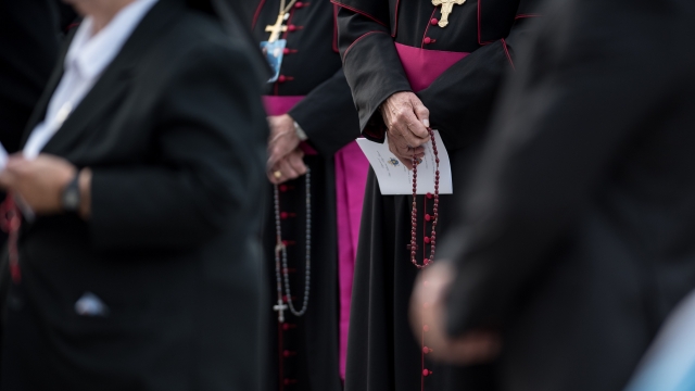 Bishop holding a rosary