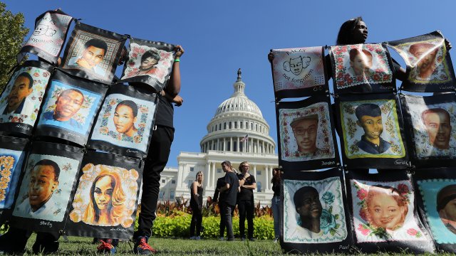 Activists calling for gun legislation salute victims of violence outside U.S. capitol Sept. 25.