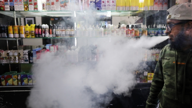 A man vapes in a store.