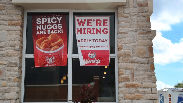 A "We're Hiring" sign on the window of a Wendy's restaurant on October 04, 2019 in Miami, Florida